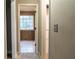 Hallway with an open doorway, neutral wall color and carpet leading to the bathroom at 703 Paul Revere Dr, Locust Grove, GA 30248