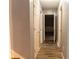Hallway with wood-look flooring and doors leading to other rooms; showcasing the home's layout and functionality at 703 Paul Revere Dr, Locust Grove, GA 30248
