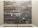 Laundry room with rustic plank wall, showcasing modern utility with a touch of character in a compact space at 703 Paul Revere Dr, Locust Grove, GA 30248