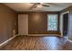Inviting living room with wood floors, a large window, and a ceiling fan, ideal for comfortable living at 703 Paul Revere Dr, Locust Grove, GA 30248