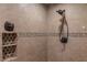 Tiled shower featuring a mosaic accent strip and a convenient corner shelf at 703 Paul Revere Dr, Locust Grove, GA 30248
