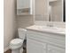 Neutral bathroom features a white vanity with storage and a view from the window at 1196 Oak Sw Rd, Lilburn, GA 30047