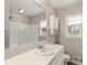 Bright bathroom with a large mirror, white sink, and a shower-tub combination at 1196 Oak Sw Rd, Lilburn, GA 30047
