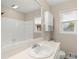 Bright bathroom with a large mirror, white sink, and a shower-tub combination at 1196 Oak Sw Rd, Lilburn, GA 30047