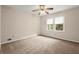 Bedroom with neutral carpet, ceiling fan, and a window providing natural light at 1196 Oak Sw Rd, Lilburn, GA 30047