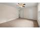 Bedroom featuring neutral carpet, ceiling fan, and closets for extra storage space at 1196 Oak Sw Rd, Lilburn, GA 30047