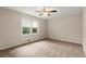 Bedroom with a ceiling fan, neutral carpet, and a window view for natural light at 1196 Oak Sw Rd, Lilburn, GA 30047