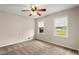 Bedroom with neutral carpet, a ceiling fan, and a window providing natural light at 1196 Oak Sw Rd, Lilburn, GA 30047