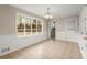 Sunlit dining room with large window overlooking the backyard and tile flooring at 1196 Oak Sw Rd, Lilburn, GA 30047