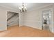 Open dining room with hardwood floors adjacent to the staircase and kitchen at 1196 Oak Sw Rd, Lilburn, GA 30047