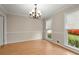 Bright dining room with hardwood floors, crown molding, and natural light at 1196 Oak Sw Rd, Lilburn, GA 30047