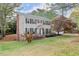 Well-maintained two-story home showcasing the manicured lawn and mature tree at 1196 Oak Sw Rd, Lilburn, GA 30047