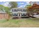Charming two-story home boasts a well-manicured lawn and mature trees at 1196 Oak Sw Rd, Lilburn, GA 30047