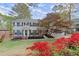 Charming two-story home with manicured lawn, colorful landscaping, and blue shutters at 1196 Oak Sw Rd, Lilburn, GA 30047