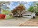 Attached two-car garage with paved driveway and landscaped front yard at 1196 Oak Sw Rd, Lilburn, GA 30047