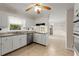Well-lit kitchen featuring white cabinets, stainless steel appliances, and a view into the dining area at 1196 Oak Sw Rd, Lilburn, GA 30047