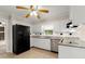 Functional kitchen with white cabinets, stainless steel appliances, and black refrigerator at 1196 Oak Sw Rd, Lilburn, GA 30047