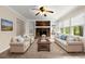 Bright living room with brick fireplace, built-in shelving, and plush seating arrangement at 1196 Oak Sw Rd, Lilburn, GA 30047