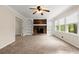 Spacious living room with brick fireplace, built-in shelves, and bright windows at 1196 Oak Sw Rd, Lilburn, GA 30047