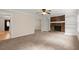 Cozy living room with brick fireplace, built-in shelving, and entryways to other rooms at 1196 Oak Sw Rd, Lilburn, GA 30047