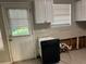Kitchen area featuring white cabinets, window, and door to outside at 3260 Rivermist Cv, Decatur, GA 30034