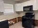 Kitchen featuring white cabinets and black appliances at 3260 Rivermist Cv, Decatur, GA 30034