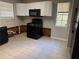 The kitchen area features white cabinets and black appliances at 3260 Rivermist Cv, Decatur, GA 30034