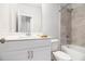 This bathroom features a tub and shower combo with stylish, neutral tile and a single sink vanity at 345 Caledonia Ct, Peachtree City, GA 30269