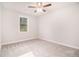 This bedroom features neutral carpet, walls, and trim and a modern ceiling fan at 345 Caledonia Ct, Peachtree City, GA 30269