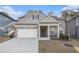 Charming single Gathering home featuring a brick and siding exterior, manicured lawn, and two-car garage at 345 Caledonia Ct, Peachtree City, GA 30269