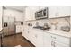 Bright kitchen features stainless steel appliances, white cabinets, and quartz countertops at 345 Caledonia Ct, Peachtree City, GA 30269