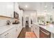 Modern kitchen featuring stainless steel appliances, gas range, granite counters and white cabinetry at 345 Caledonia Ct, Peachtree City, GA 30269