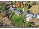 An aerial view showcasing the property's generous lot, well-maintained lawn, and in-ground pool at 5705 Windjammer Pt, Cumming, GA 30041