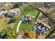 Overhead view of a house with a well-kept lawn, long driveway, and backyard pool at 5705 Windjammer Pt, Cumming, GA 30041