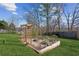 Well-maintained backyard featuring a small garden area with an arbor and stone-paved section at 5705 Windjammer Pt, Cumming, GA 30041