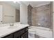 Bathroom featuring a white sink, dark vanity, and tiled tub and shower combo at 5705 Windjammer Pt, Cumming, GA 30041