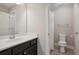 Bathroom featuring a dark vanity with a white sink, a toilet, and a shower with a white shower curtain at 5705 Windjammer Pt, Cumming, GA 30041