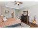 Bedroom with ensuite bath, tray ceiling, and dark wood floors at 5705 Windjammer Pt, Cumming, GA 30041