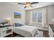 Bedroom with ceiling fan, window, and hardwood floors at 5705 Windjammer Pt, Cumming, GA 30041