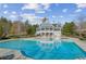 Large community pool with sun deck and clubhouse in the background at 5705 Windjammer Pt, Cumming, GA 30041