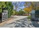 A gated entrance with a brick-paved driveway leading to the home at 5705 Windjammer Pt, Cumming, GA 30041