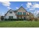 Charming brick and shingle home with a well-manicured lawn and inviting front porch at 5705 Windjammer Pt, Cumming, GA 30041