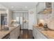 Well-equipped kitchen with stainless steel appliances, granite countertops and view into adjacent rooms at 5705 Windjammer Pt, Cumming, GA 30041