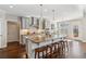 Open kitchen featuring a large island with breakfast bar and stainless steel appliances at 5705 Windjammer Pt, Cumming, GA 30041
