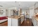 Modern kitchen with granite counters, stainless steel appliances, and center island with seating at 5705 Windjammer Pt, Cumming, GA 30041