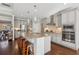 Gourmet kitchen featuring a large island, stainless steel appliances, and a view to the breakfast area at 5705 Windjammer Pt, Cumming, GA 30041