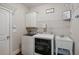 Functional laundry room with washer, dryer, and sink at 5705 Windjammer Pt, Cumming, GA 30041