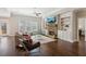 Cozy living room boasts a stone fireplace, built-in bookshelves, and a view to the backyard at 5705 Windjammer Pt, Cumming, GA 30041