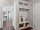 Mudroom with built-in storage cubbies, hooks, and bench at 5705 Windjammer Pt, Cumming, GA 30041