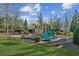 Community playground with slides, climbing structures, and benches at 5705 Windjammer Pt, Cumming, GA 30041